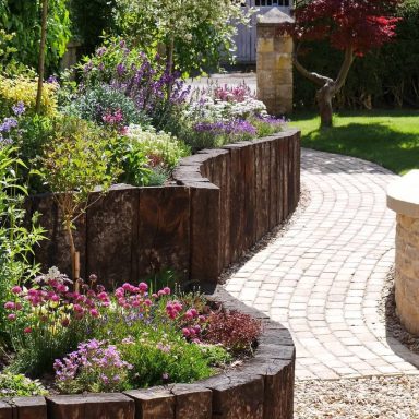 A stone cobble pathway with planters