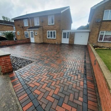 A grey and red concrete block paving driveway