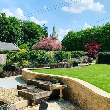 A garden featuring walling and wooden planters