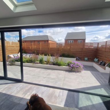 A grey porcelain patio with bi fold doors
